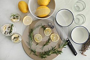 Flat lay composition with natural homemade mosquito repellent candles and ingredients on white table