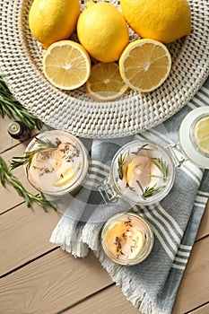 Flat lay composition with natural homemade mosquito repellent candles on wooden table