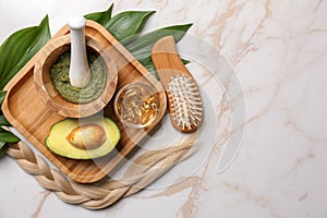 Flat lay composition with natural ingredients for hair care on marble background