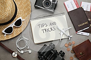 Flat lay composition with notebook on grey table. Tips and Tricks