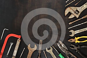 Flat lay composition with old tools on a dark wooden background