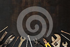 Flat lay composition with old tools on a dark wooden background. Top view