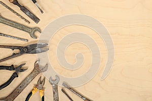 Flat lay composition with old tools on a light wooden background