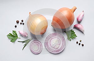 Flat lay composition with onions and spices on background