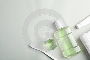 Flat lay composition with oral care products and space for text on light background. photo