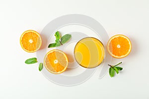 Flat lay composition with orange juice, oranges and mint on white background, space for text. Citrus drink