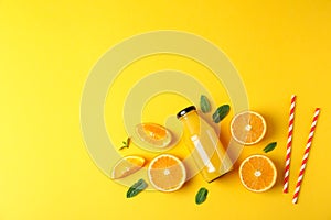 Flat lay composition with oranges, tubules and orange juice in bottle, space for text