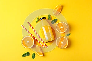 Flat lay composition with oranges, tubules and orange juice in bottle, space for text