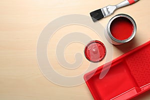 Flat lay composition with paint can and brush on wooden background.