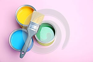 Flat lay composition with paint cans and brush on color background. photo