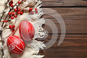 Flat lay composition with painted red Easter eggs on wooden table