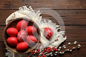 Flat lay composition with painted red Easter eggs on wooden table