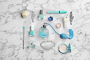 Flat lay composition with perfume bottles, jewelry and decorative cosmetics on white