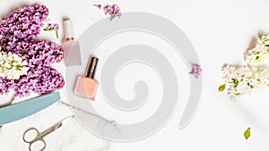 Flat lay composition with personal care products with branches of lilac on white table.background. Nails care. Manicure, pedicure