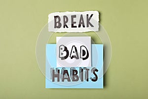 Flat lay composition with phrase Break Bad Habits on green background