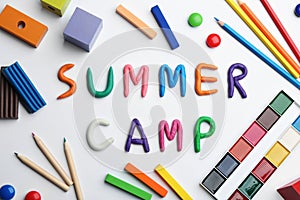 Flat lay composition with phrase SUMMER CAMP made of colorful clay on background