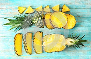 Flat lay composition with pineapple slices on wooden background