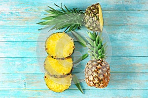 Flat lay composition with pineapple slices on wooden background