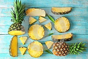 Flat lay composition with pineapple slices on wooden background