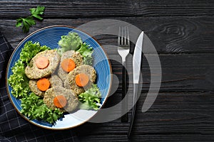 Flat lay composition with plate of traditional Passover Pesach gefilte fish on wooden background