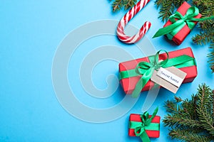 Flat lay composition with presents from secret Santa on light blue background, space for text