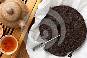 Flat lay composition with pu-erh tea on wooden table