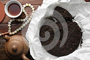 Flat lay composition with pu-erh tea on wooden table