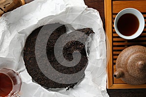 Flat lay composition with pu-erh tea on wooden table