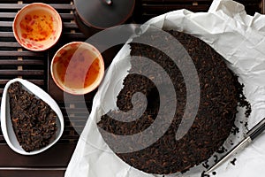 Flat lay composition with pu-erh tea on wooden tray