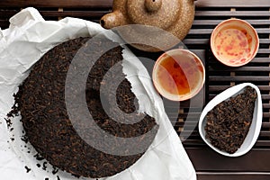 Flat lay composition with pu-erh tea on wooden tray