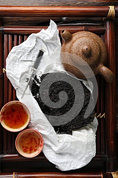 Flat lay composition with pu-erh tea on wooden tray