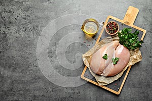 Flat lay composition with raw chicken breasts and space for text