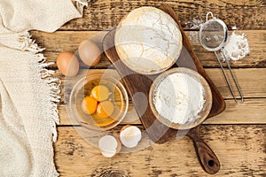 Flat lay composition with raw eggs and other ingredients on table. Baking pie