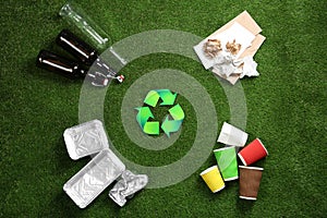 Flat lay composition with recycling symbol and different garbage