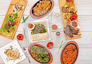 Flat lay composition of restaurant menu. top view of hot meals, beef steaks, roasted chicken and delicious sauses with fresh herb