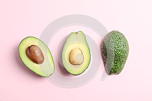 Flat lay composition with ripe avocados on color background, space for text