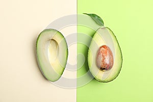 Flat lay composition with ripe avocados on color background, space for text