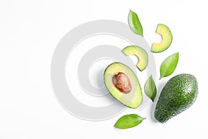 Flat lay composition with ripe avocados on white background, space for text photo