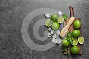 Flat lay composition with ripe limes, ice cubes