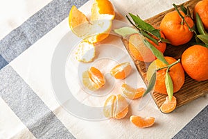 Flat lay composition with ripe tangerines on cloth.
