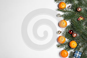 Flat lay composition with ripe tangerines, fir branches and Christmas decor on background. Space for text