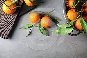 Flat lay composition with ripe tangerines on grey background.