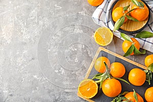 Flat lay composition with ripe tangerines on grey background