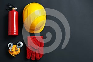Flat lay composition with safety equipment on black background