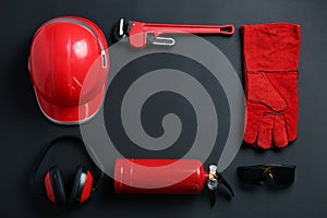 Flat lay composition with safety equipment and space for text on black