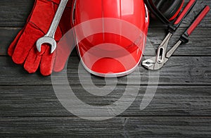 Flat lay composition with safety equipment on wooden background