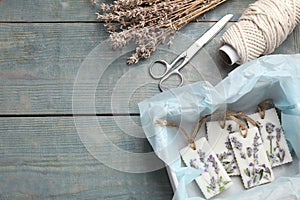 Flat lay composition with scented sachets on blue wooden table, space for text