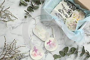 Flat lay composition with scented sachets on white marble table