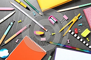 Flat lay composition with school stationeries on grey background photo