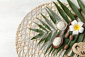 Flat lay composition with Shea butter and tropical leaf on light background. Space for text photo